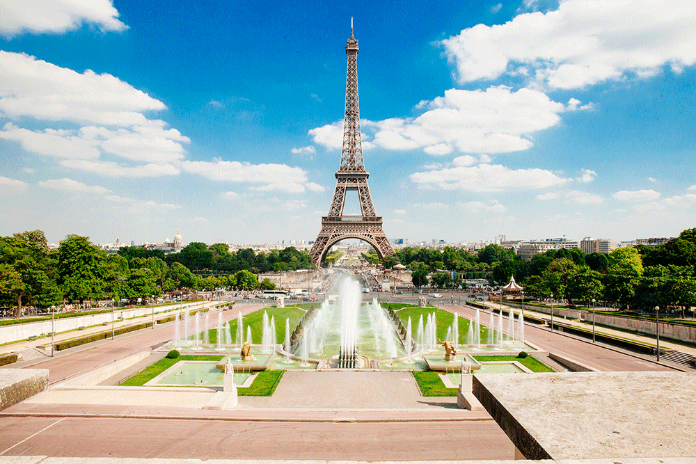 a large fountain with eiffel tower in view 
