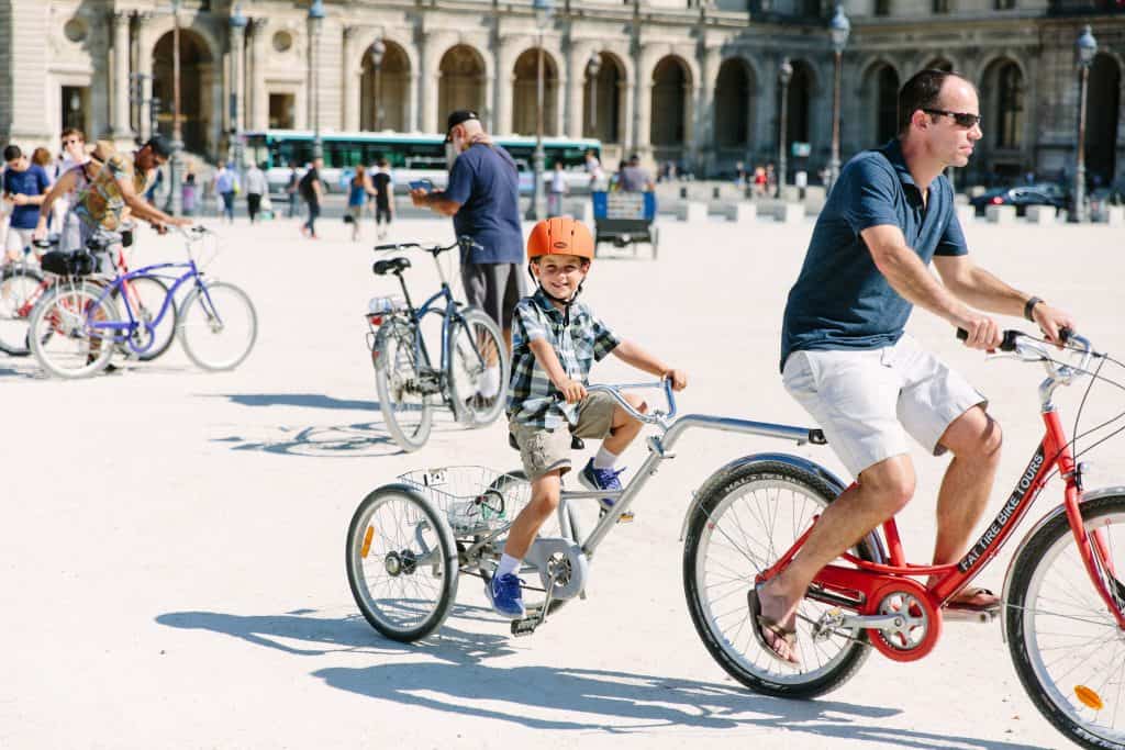 child on a tandem bike in paris, france