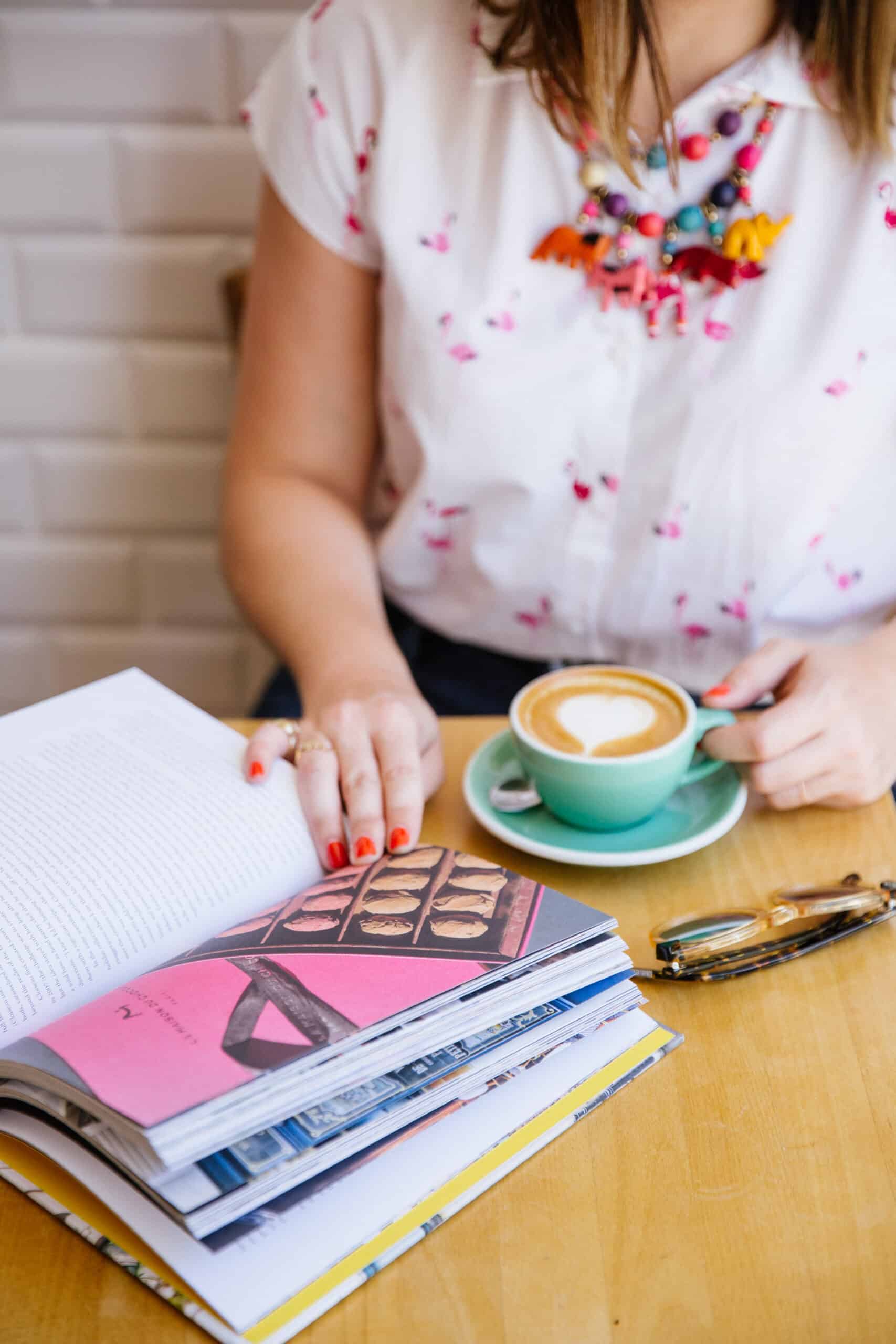 girl reading book at coffee shop in Paris.