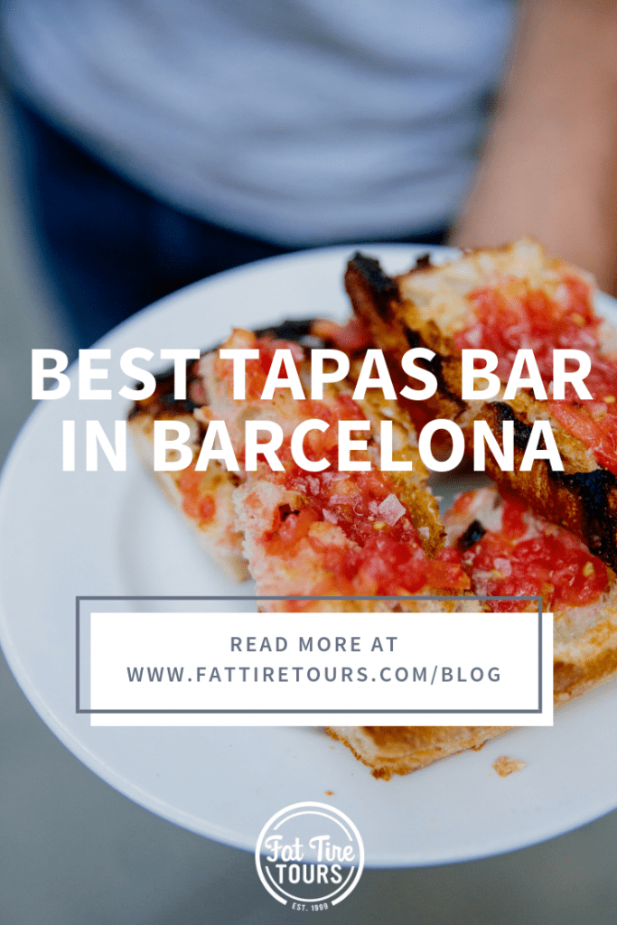 man holding tapas on a plate in barcelona