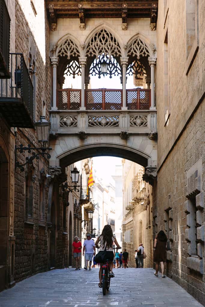 girl on bike in under gothic quarter