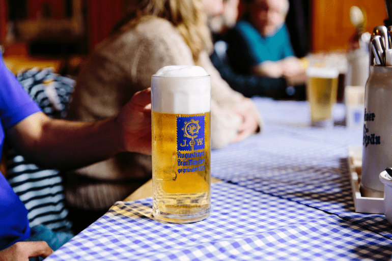 Close up of a large beer stein from Augustiner Bräu München (brewery in Munich) at a traditional German restaurant.