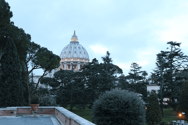 St. Peter's Basilica as seen from the Vatican Museums courtyard at sunrise.