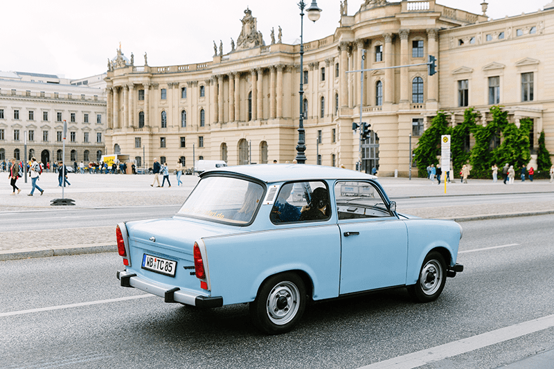 A light blue vintage car in the streets of Berlin