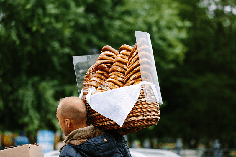A man carries a large basket of pretzels through the street in Germany