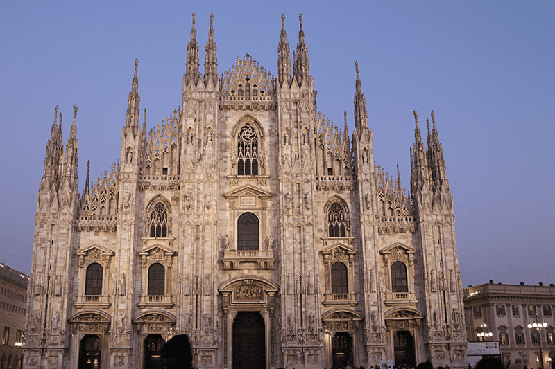 Exterior facade of the Milan Duomo (Milan Cathedral) at night.