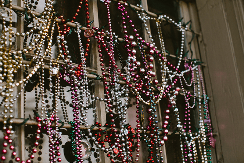 Iconic colorful beads hanging in a window in New Orleans, Louisiana.