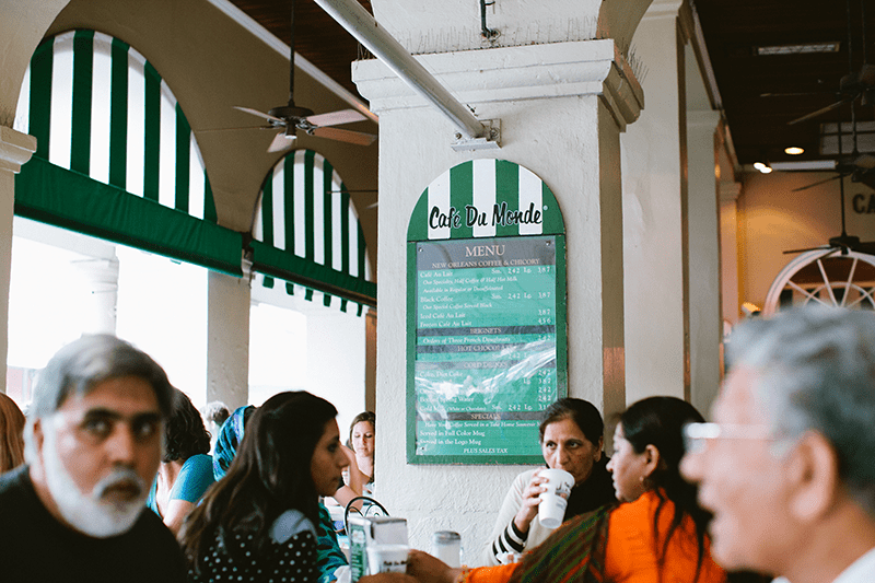 Scenes inside the bustling Cafe du Monde in New Orleans, famous for their beignets.