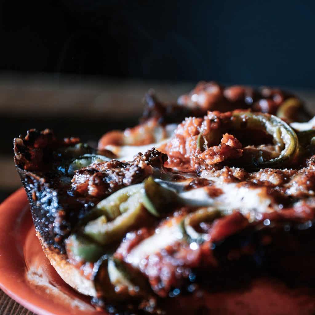 Close up of Pequod's Pizza deep dish in Chicago, Illinois.