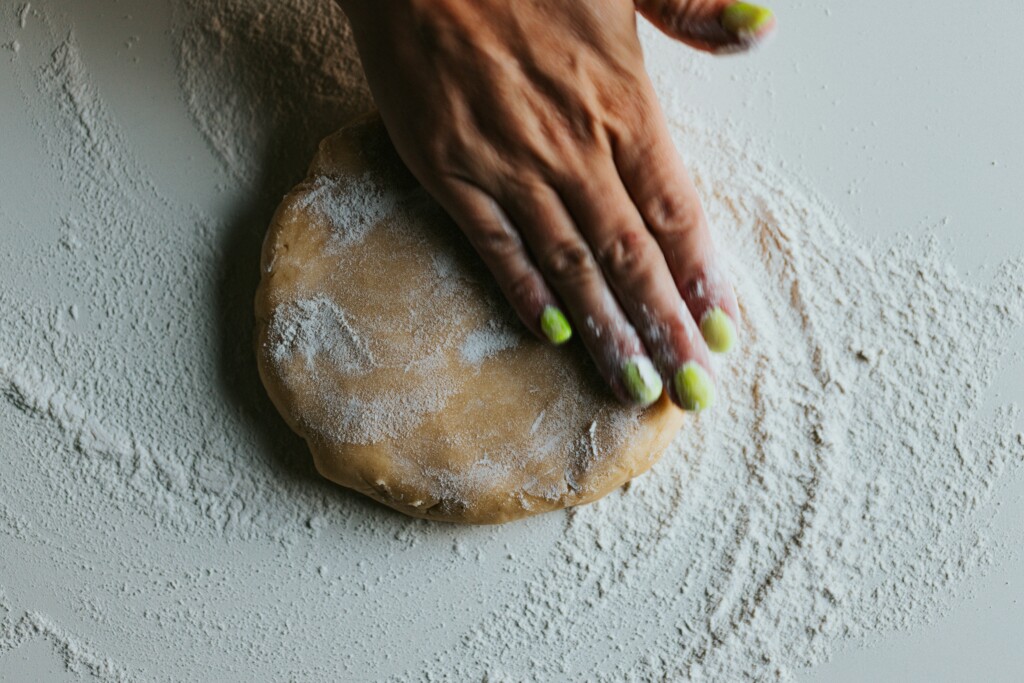 A person pressing down chickpea flour 