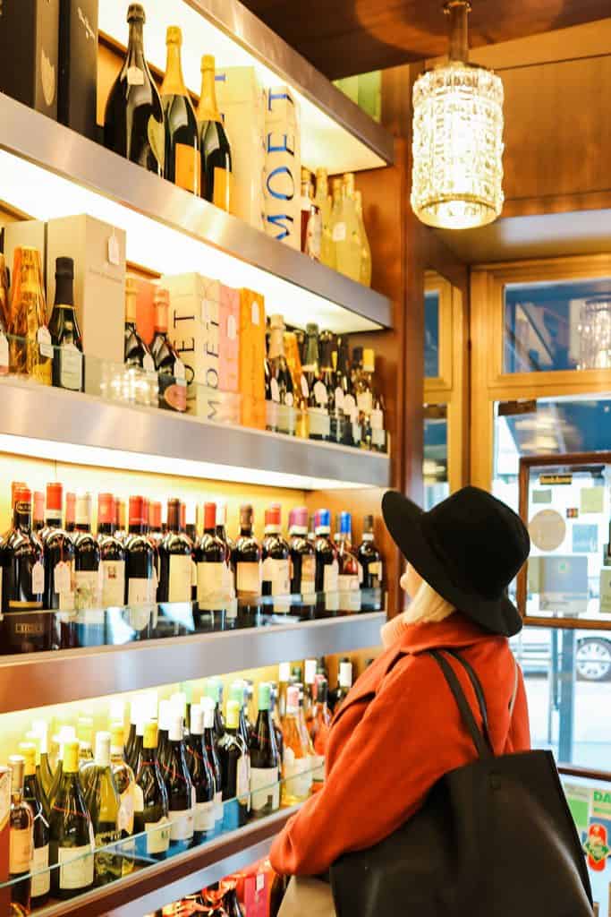 woman looking at wine in milan, italy