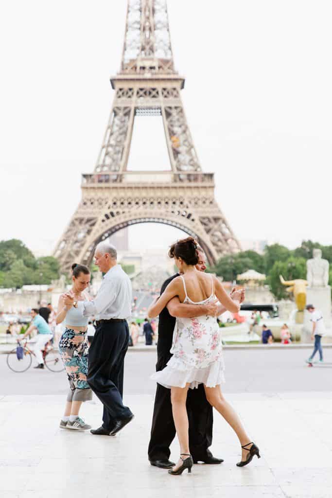 People dance at Trocadero with the Eiffel tower in the background during Fête de la Musique in Paris, France