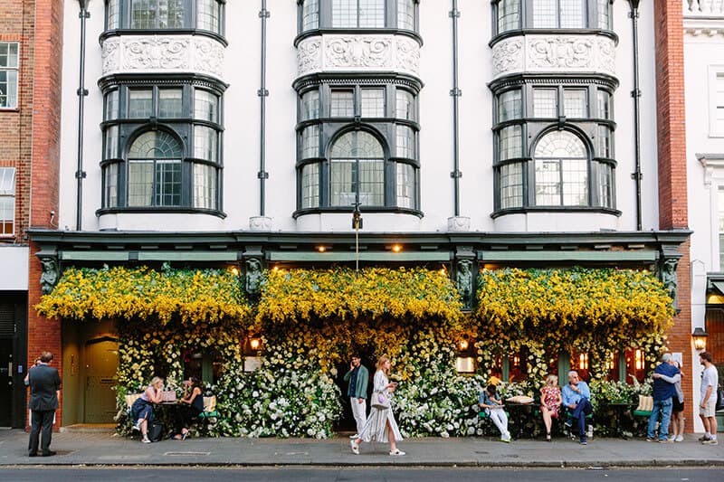 A building in central London covered in flowers