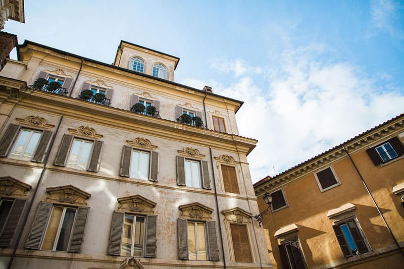 Looking up to traditional Roman buildings on a sunny day