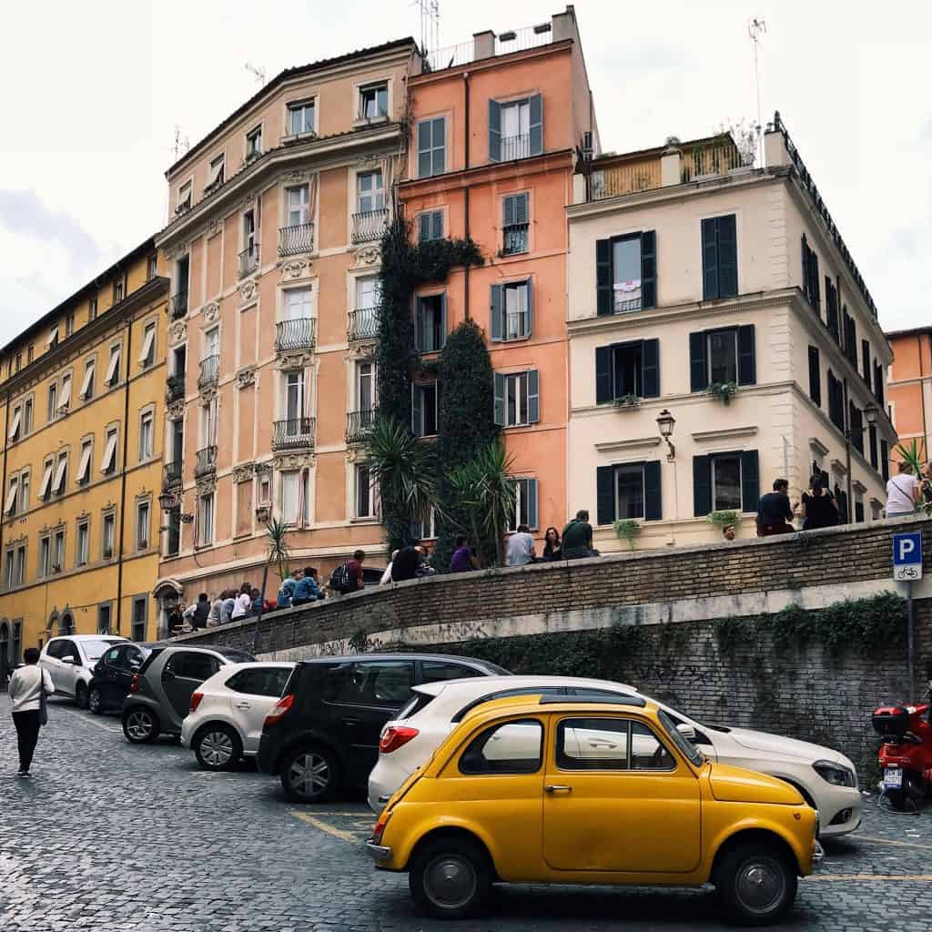 Yellow car in the colorful streets of Rome, Italy