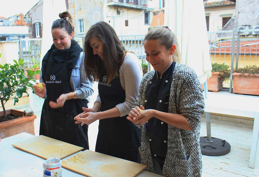 three women making pasta in a pasta class
