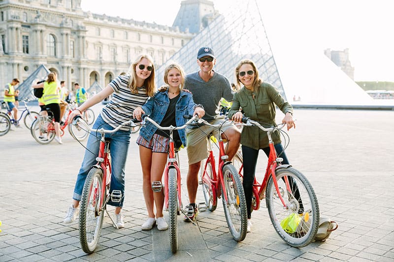 A family posed with their bikes at the Louvre in Paris, France