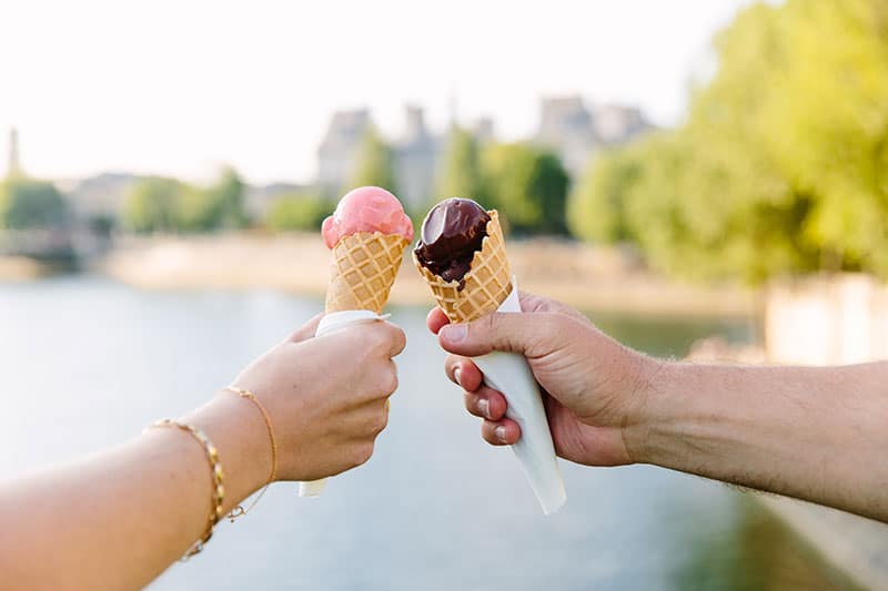 Two cones of Berthillon ice cream along the River Seine in Paris, France