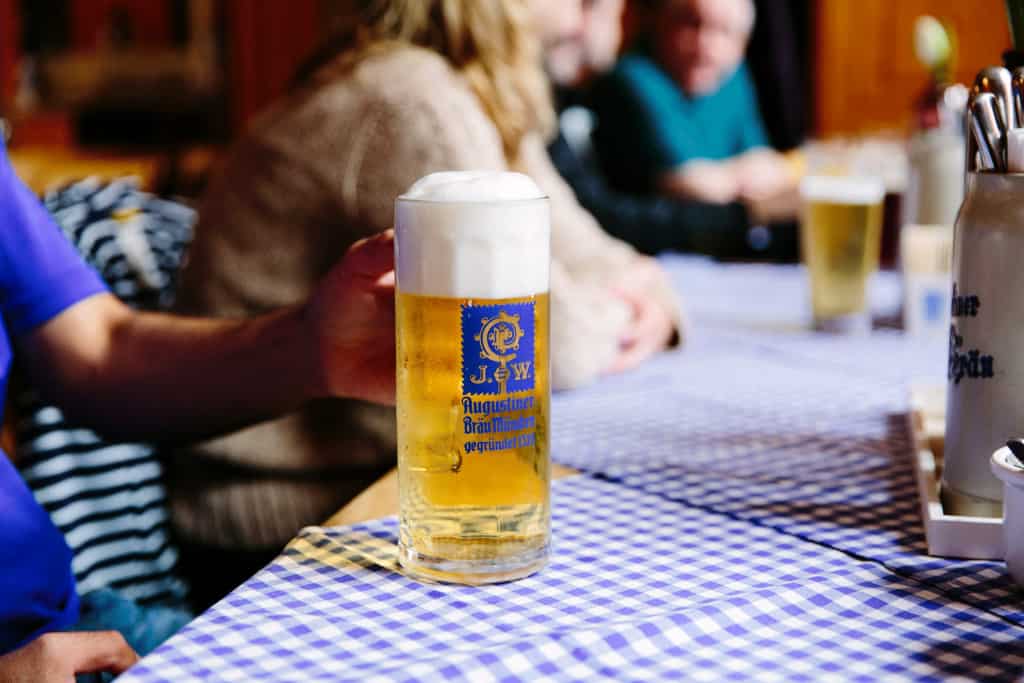 Close up of a large beer stein from Augustiner Bräu München (brewery in Munich) at a traditional German restaurant.