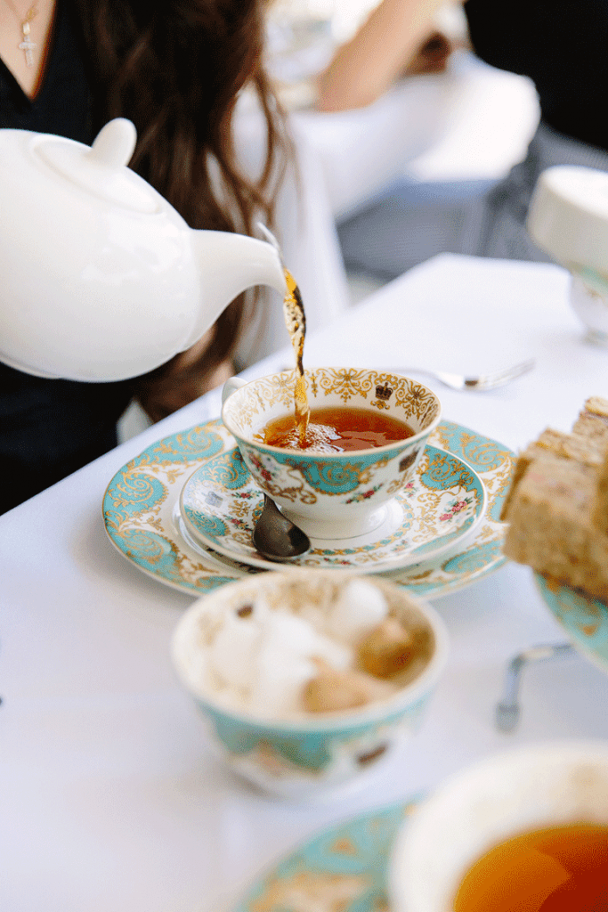 pouring tea at kensington palace as a cozy winer drink