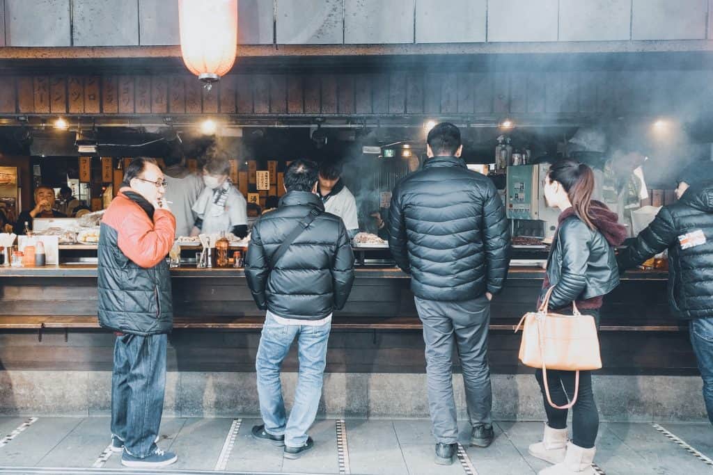 people waiting at a street food vendor in nakano, tokyo bike tour