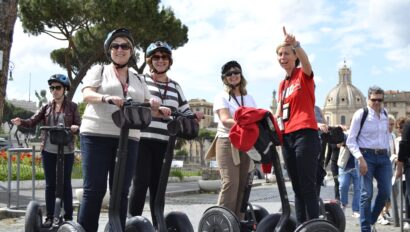 A guide points out the sites to a group on Segways in Rome, Italy