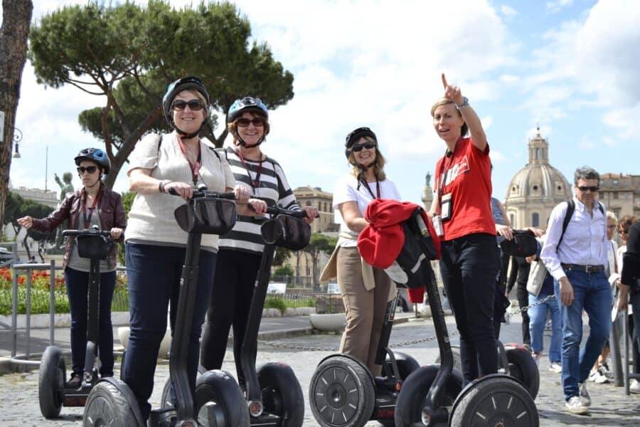 A guide points out the sites to a group on Segways in Rome, Italy