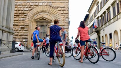 A group admires the architecture while on bikes in Florence, Italy