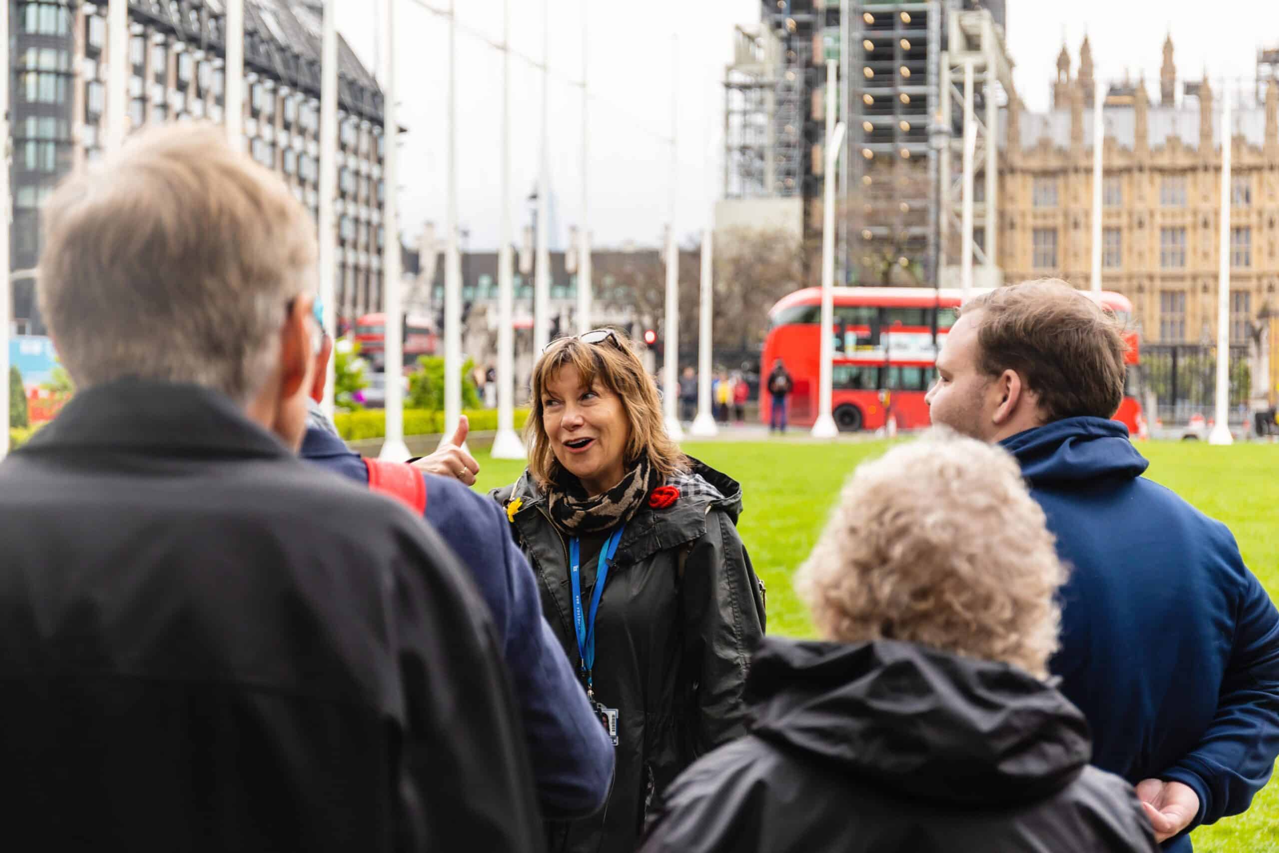 A guide leads a group through London, England
