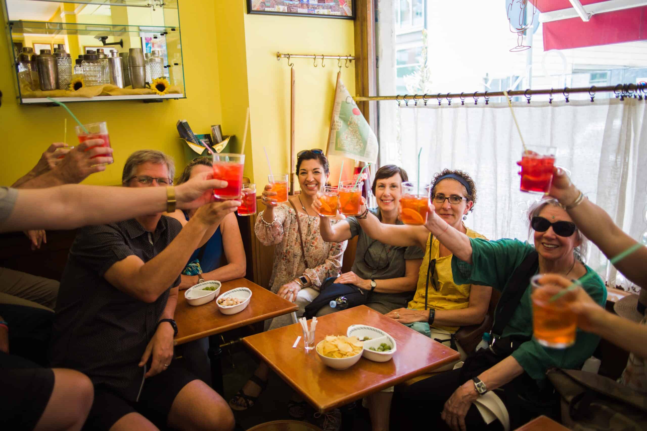 A group cheers with Aperol Spritz in Milan, Italy