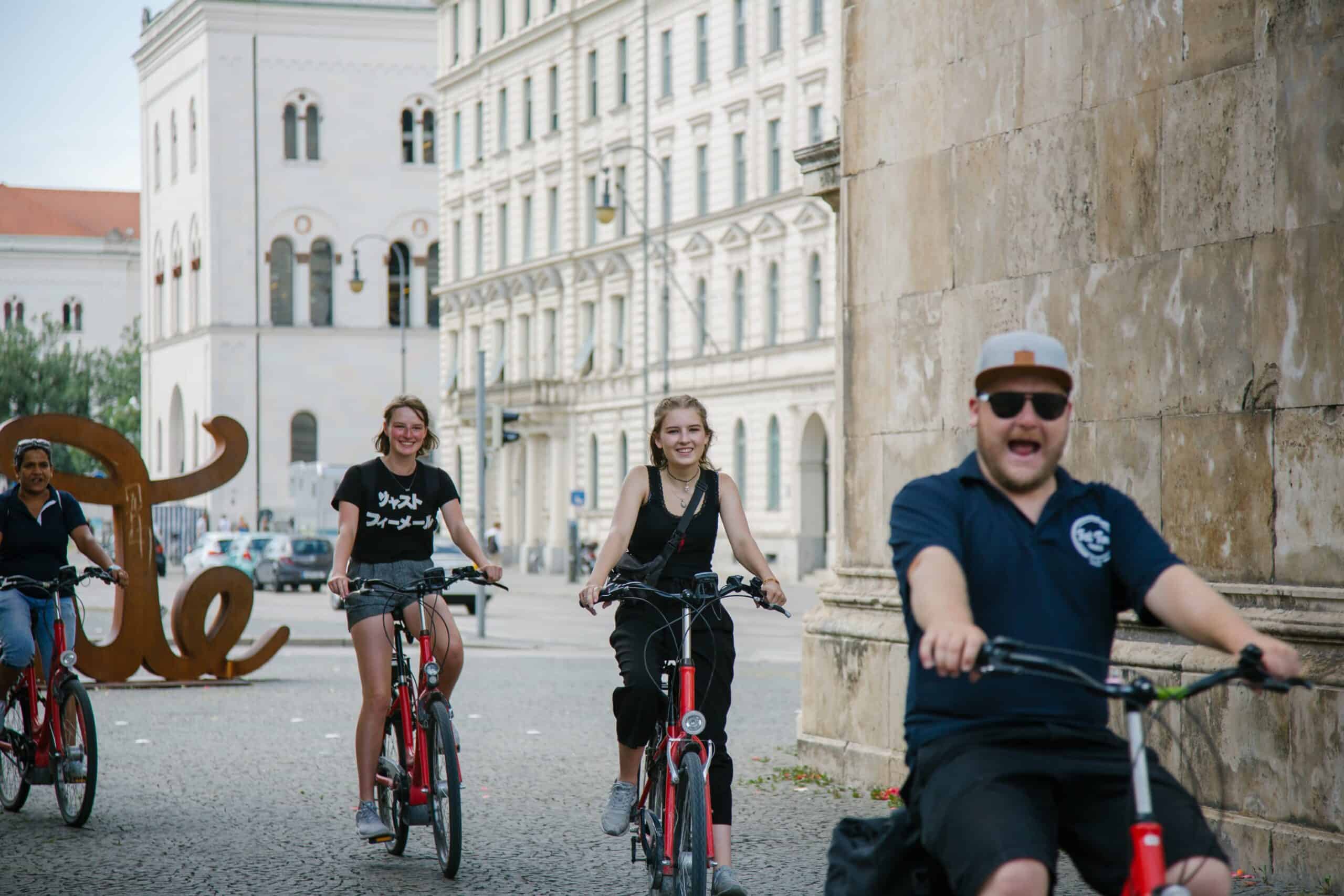 The group rides by the 'Love' sculpture in Munich, Germany