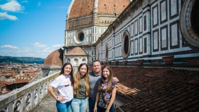 A family poses for a photo on the rooftop of the Duomo in Florence, Italy