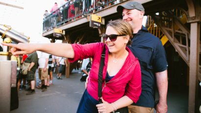 A couple points at a Parisian landmark from the Eiffel Tower in Paris, France