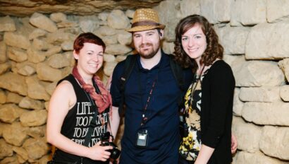 A group of friends poses for a photo in the Catacombs in Paris, France