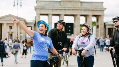The tour guide points out sites near the Brandbenburg Gate while on a Segway in Berlin, Germany