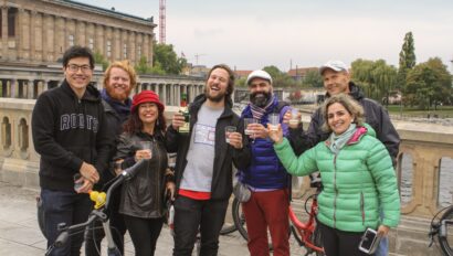 A group cheers their drinks on a bridge in Berlin, Germany