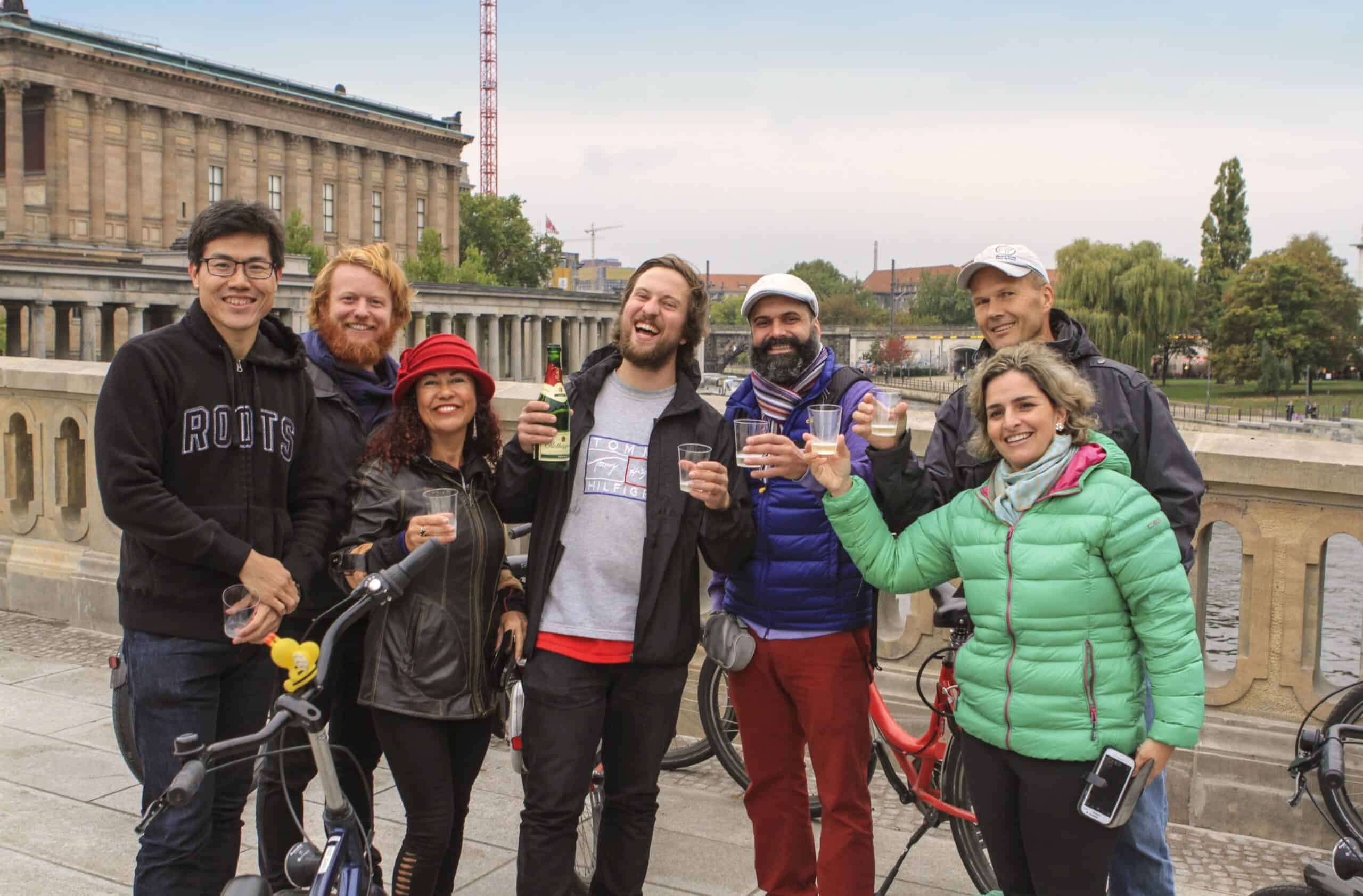 A group cheers their drinks on a bridge in Berlin, Germany