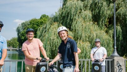 A guide and the group smile while riding Segways in Munich, Germany