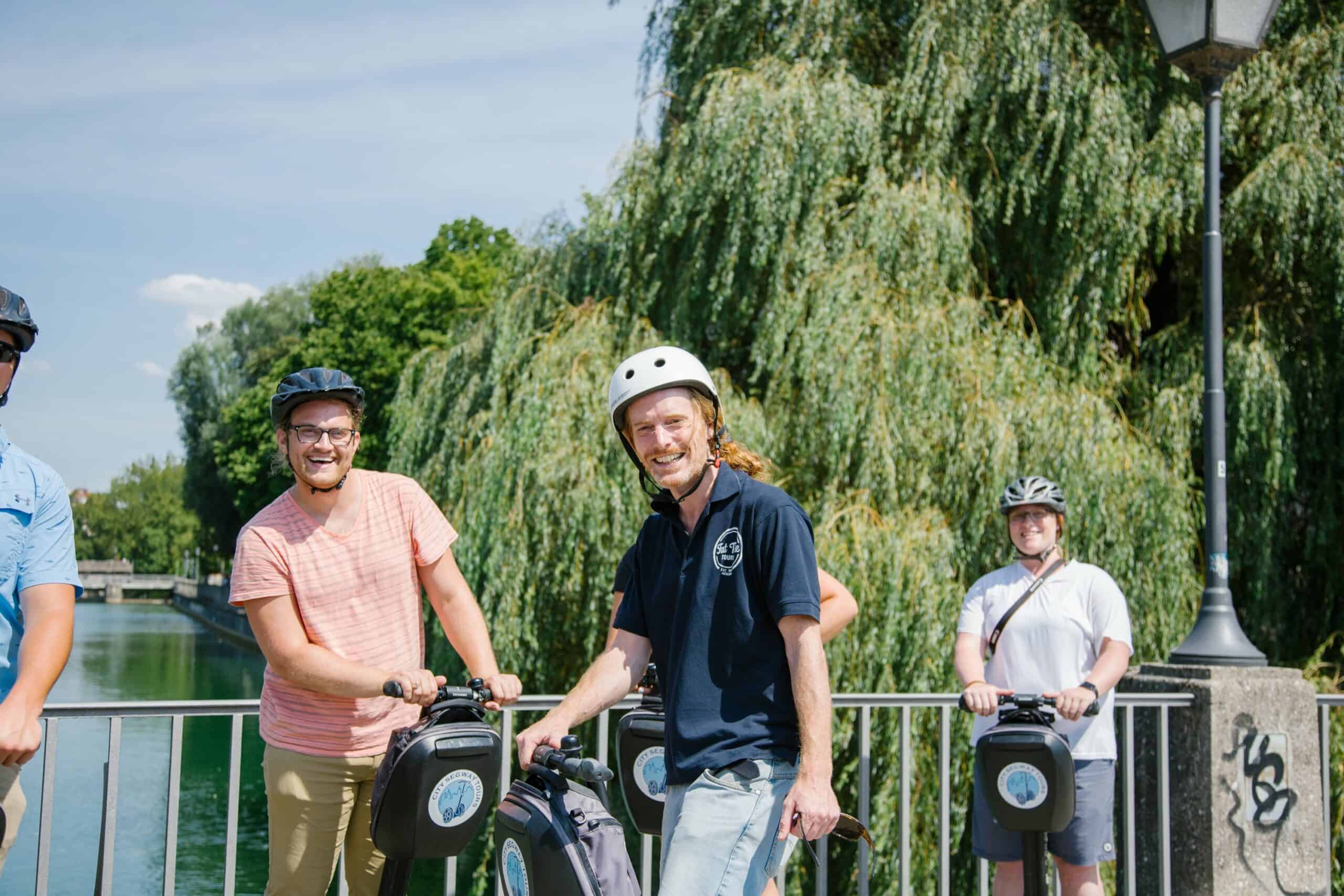 A guide and the group smile while riding Segways in Munich, Germany
