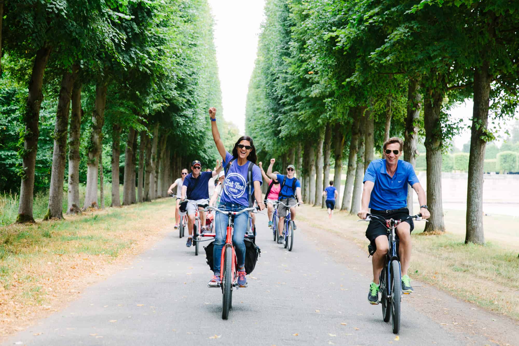 A tour guide leads her group around the Grand Canal in Versailles.