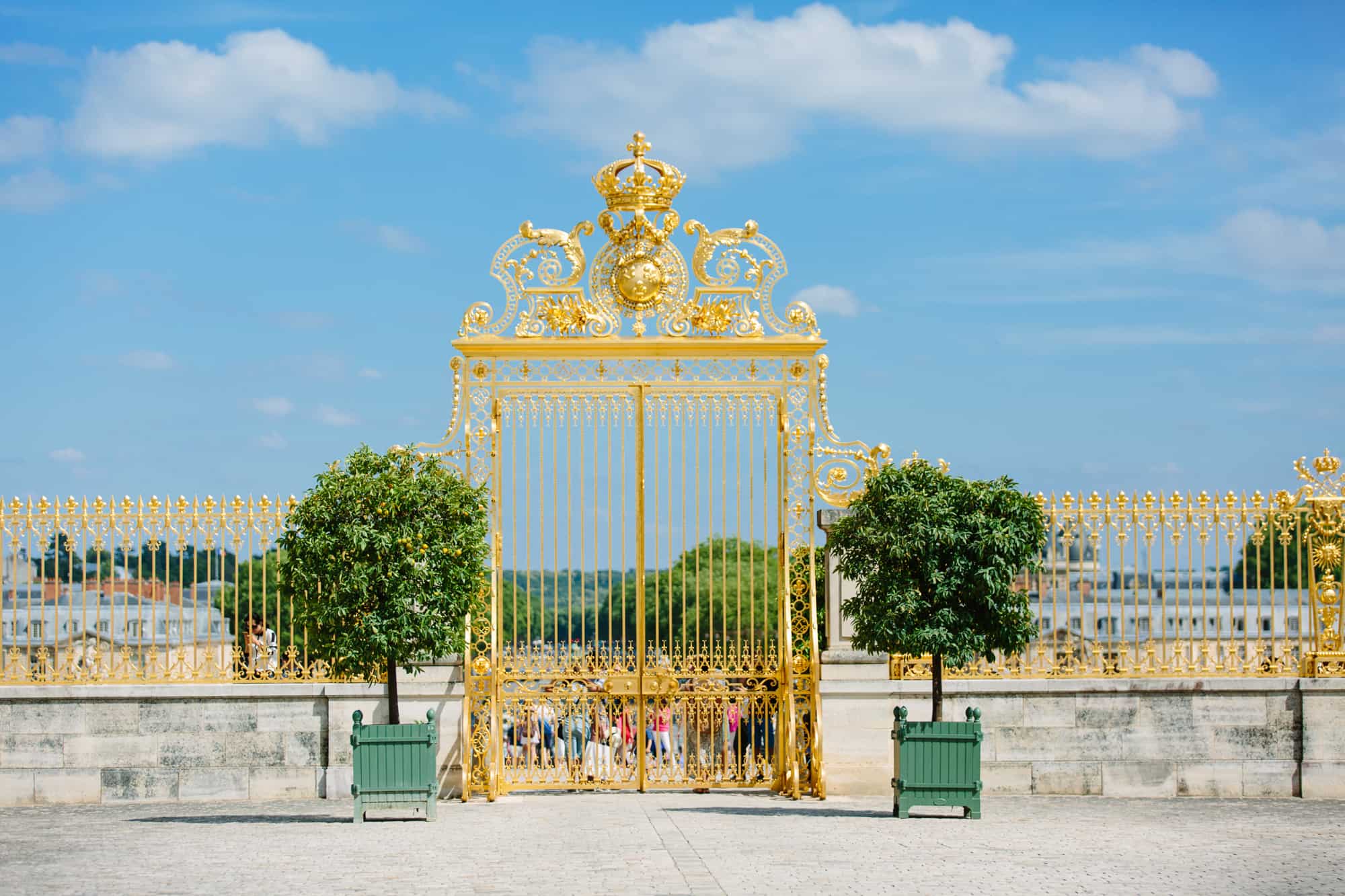 A golden gilded entry gate to the Versailles park.