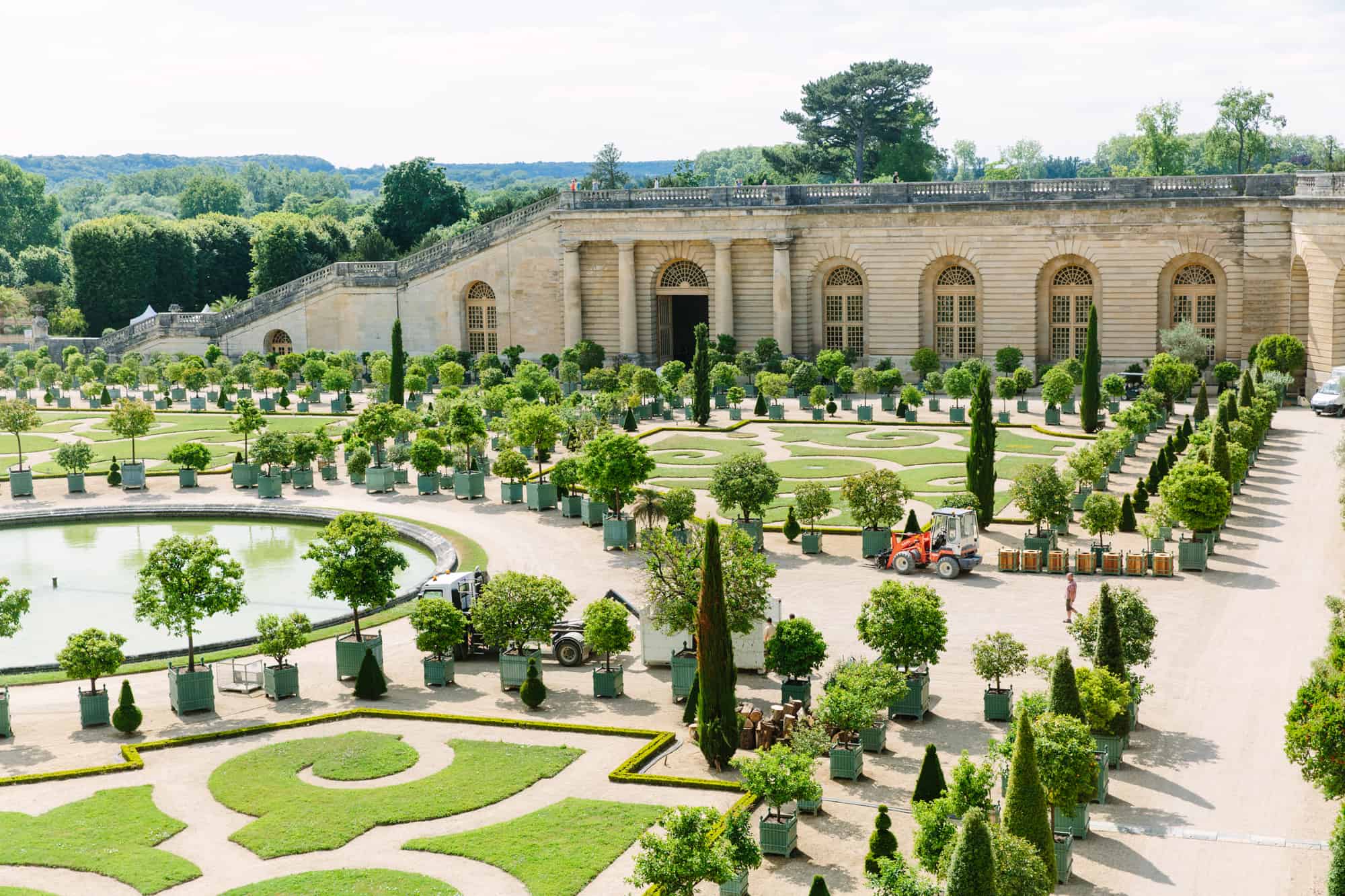 The curated orangerie gardens within the palace of Versailles' park.