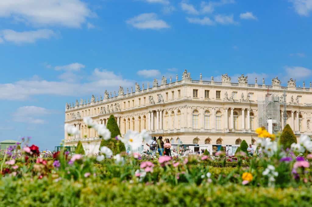 The Chateau of Versailles with flowers in the foreground