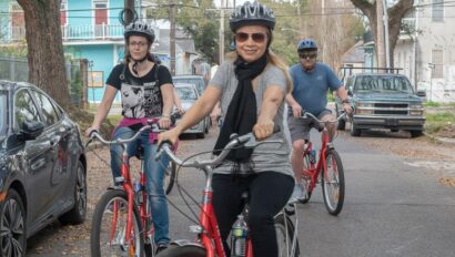 A group smiles while riding bikes in the French Quarter in New Orleans, Louisiana