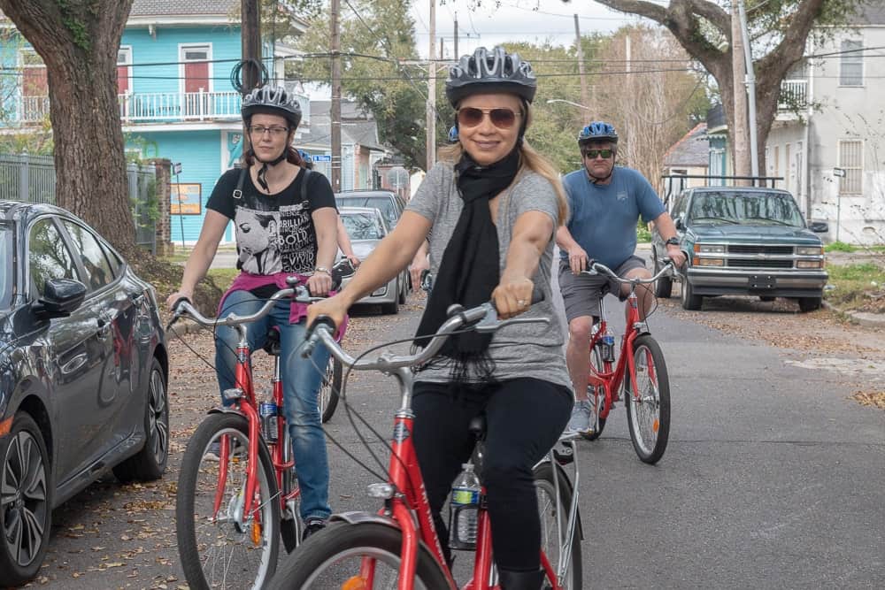 A group smiles while riding bikes in the French Quarter in New Orleans, Louisiana