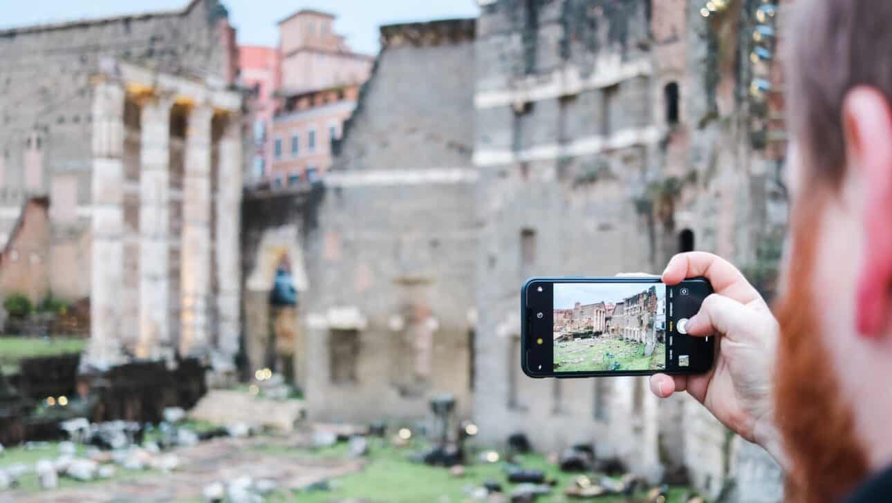 A man takes a photo of the archeological site on Palantine Hill in Rome, Italy