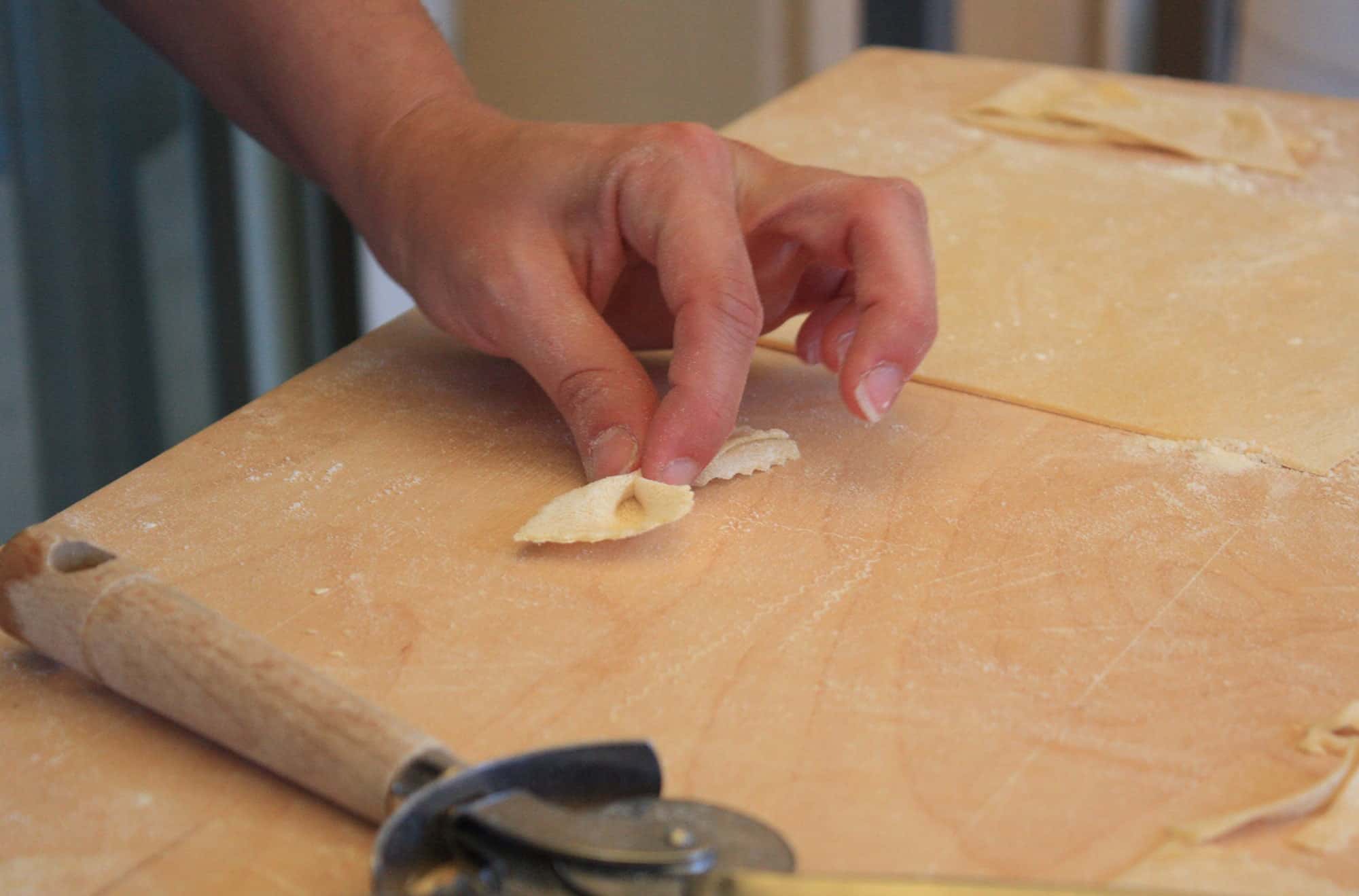 Bowtie pasta is pinched into place in Rome, Italy