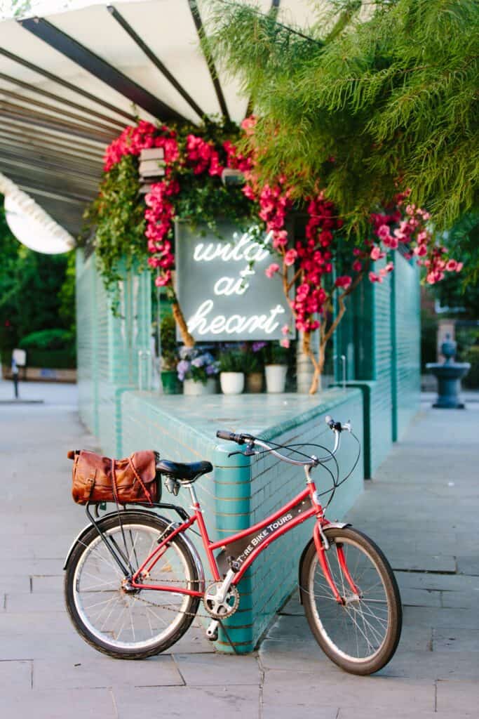 A Fat Tire Tours bike in front of a sign reading 'Wild at Heart' in London, England