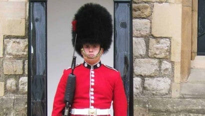 A soldier in the Queen's Guard stand at attention in London, England