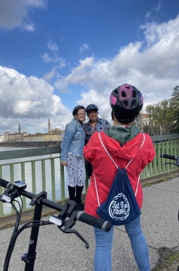 A guide takes a picture of a couple in Florence, Italy